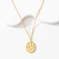 Detail of gold oval pendant with CNC flower engraving and Good Luck lucky charm text - Oval Four-leaf Clover Necklace