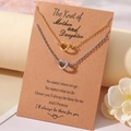 Mother-daughter knot pendant necklaces in gold and silver finish on a gift card - Necklace And Card / Gold And Steel Mother Daughter Theme