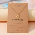 Goldene Edelstahlkette mit Herz-Augen-Anhänger auf einer Kraftpapier-Geschenkkarte - Böses Auge Gold (N00172)