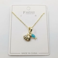 Detail of gold necklace featuring seashell pendant with zircon and blue fish charm - Whale Shell Pendant With Chain And Packaging