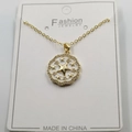 Detailed macro view of a gold starburst heart pendant with inlaid crystals on a card - White Enamel Star Pendant With Chain And Box