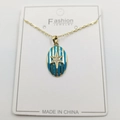 Detail of gold oval pendant with blue enamel stripes and a sparkling star inlay - Hexagram Enamel Oval Pendant With Chain And Box