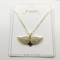 Golden necklace featuring a crystal-pave angel wing pendant on a jewelry display card - Heart Wings Pendant With Chain And Box