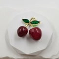 Exquisite cherry pendant with red resin fruit and green crystal leaves in gold finish - Glossy Cherry Pendant