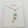 Golden fish bone necklace with blue enamel and sparkling zircon on white display card - Tropical Fish Pendant With Chain And Packaging
