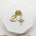 Detailed close-up of gold-plated pendant with sparkling zircon star and letter D charm - Script Letter D (Style 1)