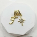 Close-up of gold pendant with textured ring, letter T and pavé zircon star detail - Script Letter T (Style 5)