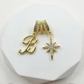 Detailed view of a gold zodiac star pendant with zircon stones and letter B charm - Script Letter B (Style 6)