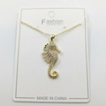 Golden seahorse pendant necklace with sparkling zircon crystals on white jewelry card - Seahorse Pendant with Chain and Packaging