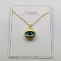 Golden necklace featuring a blue evil eye pendant with radiant texture on white jewelry card - Sun Texture Style D / Pendant And Chain With Packaging