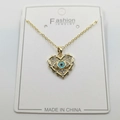 Gold heart evil eye necklace with blue stone inlay on a white display card - Golden Heart Style F / Pendant And Chain With Packaging