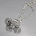 Macro detail of polished stainless steel dumbbell pendant with a sleek curb chain - Steel Color Necklace with Pendant