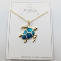 Golden sea turtle pendant necklace with teal enamel finish and white crystal accents - Enamel Blue Turtle Pendant + Chain + Packaging