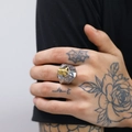 Close-up of a men's vintage gothic stainless steel ring with a golden skull on hand - US 7 / Two-tone (Gold & Silver)