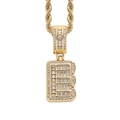 Macro view of iced out letter E pendant with baguette cubic zirconia on a gold rope chain - 3mm*60cm / E Gold + Stainless Steel Rope Chain
