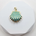 Gold-plated shell pendant featuring turquoise enamel stripes on a white geometric stand - Shell Style 6