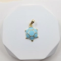 Turtle pendant with sky blue enamel shell and golden geometric pattern on marble stand - Starfish Style 2
