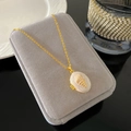 Detail of a vintage gold locket necklace with mother of pearl and shell inlay on velvet - White Mother Of Pearl Locket Style (W970)
