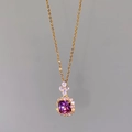 Close-up of a square purple zircon pendant on a gold halo chain with small clear diamonds - Purple