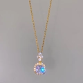 Close-up of golden necklace with square purple zircon and clover pave diamond pendant - White