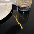 Detail of gold-plated clover tassel necklace with micro-pave cubic zirconia on silk - Five Fleur-de-lis Rhinestone Necklace (X2026)