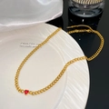 Macro detail of gold Cuban link necklace featuring a vibrant red heart zircon pendant - Single Red Heart Pendant Necklace (X2168)