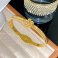 Bracelet floral doré élégant avec micro-cristaux pavés et fermoir à cliquet - Style Fleur Unique Pavé (X2080)