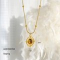 Vintage style gold necklace featuring a round brown tiger eye stone pendant and beads - Oval Hollow Cross Bead Style