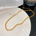 Detail of gold Cuban chain necklace featuring a heart-shaped zircon and lobster clasp - Single White Heart Pendant Necklace (X2171)