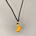 Macro detail of a gold fortune bag pendant with Fu character and black braided cord - Fu Character Money Bag (X2196)