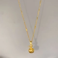 Detailed view of golden apple pendant with star-pattern texture on a fine link chain - Apple Shape (W694)