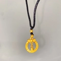 Macro view of a gold lotus bell pendant with butterfly bow detail and braided cord necklace - Bow Bell Ring (X2183)