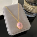Vintage gold locket necklace with pink enamel and shell detail on a velvet surface - Pink Locket Shell Style (W968)