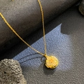 Gold round locket necklace with micro-paved crystals and clover motif on volcanic stone - Round Yellow Zirconia Flower