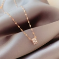 Elegant rose gold hourglass necklace with cubic zirconia on smooth satin background - Rose Gold