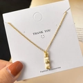 Elegant gold bamboo necklace featuring cream cat-eye stones and crystal accents on card - O Chain / Gold Bamboo Necklace (O-Chain)