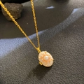 Golden oval locket necklace with mother of pearl inlay and center pearl detail - Mother of Pearl Locket (W1016)