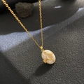 Vintage gold locket necklace with white mother-of-pearl oval pendant on black stone - White Shell Gold Relief (W1023)