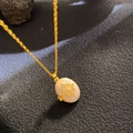 Vintage gold necklace with white oval mother-of-pearl pendant and geometric floral motif - Shell Material Geometric (W1044)