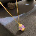 Golden necklace with purple enamel locket and blue gem pendant on textured background - Purple Enamel Blue Gem (W1054)