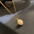 Vintage gold oval locket necklace with white shell inlay and floral relief detail - Shell Relief Gold Flower (W1068)