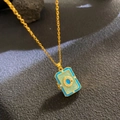 Golden chain necklace with blue and green enamel locket pendant featuring crystal accents - Blue Green Book Pendant (W1075)