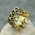Detailed close-up of golden crown ring with vintage black engraving on stone base - Black Gold Distressed / US 7