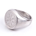 Macro view of Nordic Viking compass ring with engraved runes on brushed steel surface - US 6 / Steel