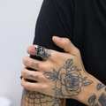 Detail of adjustable stainless steel double skull ring on tattooed hand punk style - US 7 / Steel