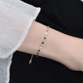 Minimalist silver sparkling water wave chain anklet shown on a woman wrist - 16+5cm / Lip Chain Bracelet / Steel