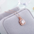 Elegant rose gold square pendant necklace with sparkling zircon halo on jewelry box - Square Necklace (O-Chain) / Rose Gold