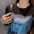Macro detail of a double-layered bear pendant necklace encrusted with white cubic zirconia - Single Rhinestone Bear Necklace