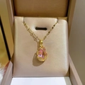 Elegant gold tulip necklace featuring a water-drop pink crystal pendant on a gift box - Gold