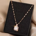 Elegant rose gold dancing zircon pendant necklace displayed on champagne satin fabric - Rose Gold Large Static Pendant (Lip Chain)